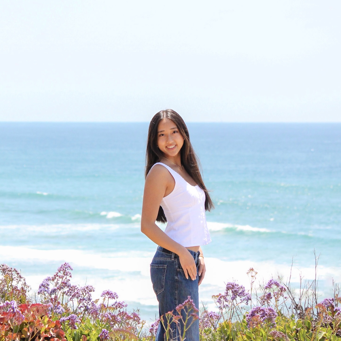 Lauren smiling with the beach in the background